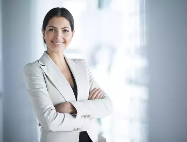 smiling-female-business-leader-with-arms-crossed