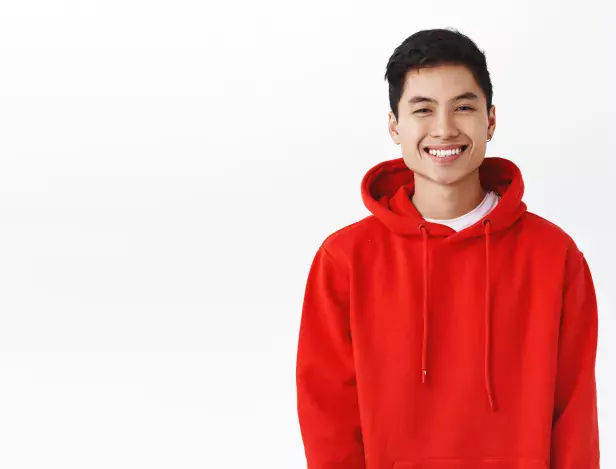 portrait-happy-smiling-asian-hipster-man-young-guy-red-hoodie-smiling-cheerful-looking-camera-enthusiastic-express-positive-mood-being-delighted-satisfied-white-wall